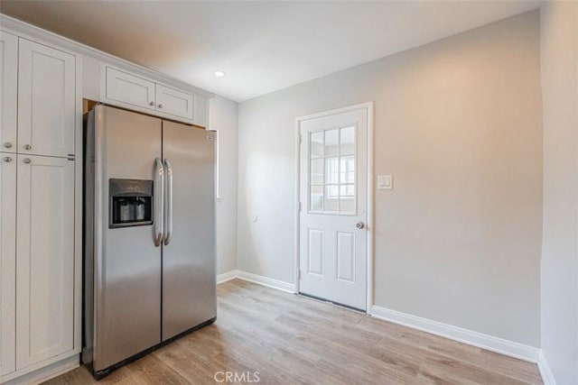10113 Harvest Ave, Santa Fe Springs, CA 90670 - kitchen featuring stainless steel refrigerator with ice dispenser, baseboards, light wood-style flooring, recessed lighting, and white cabinetry