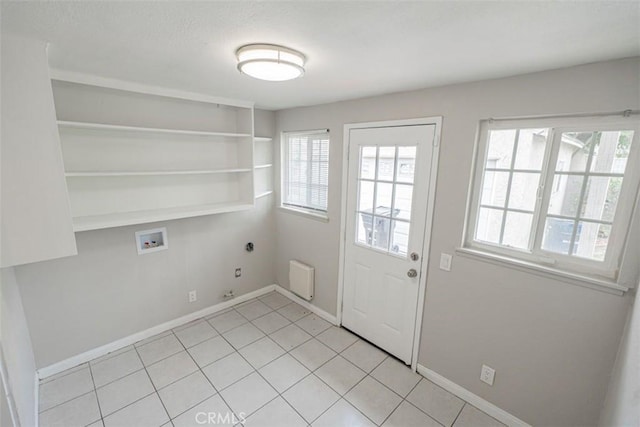 10113 Harvest Ave, Santa Fe Springs, CA 90670 - washroom featuring washer hookup, healthy amount of natural light, light tile patterned floors, and baseboards