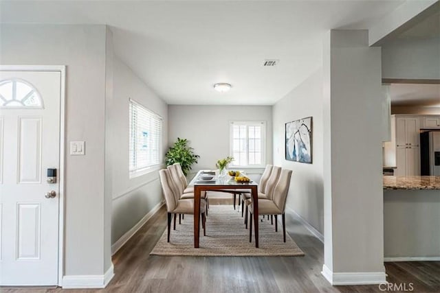 10113 Harvest Ave, Santa Fe Springs, CA 90670 - dining area with healthy amount of natural light, wood finished floors, and baseboards