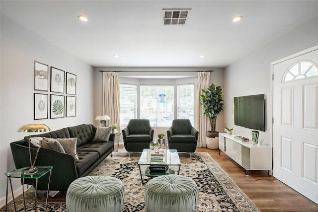 10113 Harvest Ave, Santa Fe Springs, CA 90670 - living room featuring healthy amount of natural light, wood finished floors, and recessed lighting