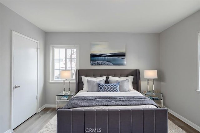 10113 Harvest Ave, Santa Fe Springs, CA 90670 - bedroom featuring wood finished floors and baseboards
