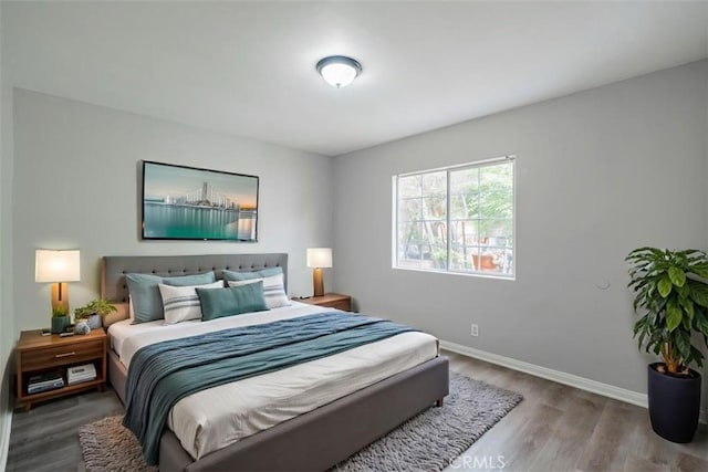 10113 Harvest Ave, Santa Fe Springs, CA 90670 - bedroom featuring wood finished floors and baseboards