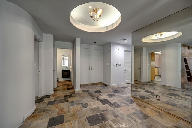 12841 Bloomfield St Unit 103, Studio City, CA 91604 - corridor with stone finish flooring, baseboards, and a raised ceiling