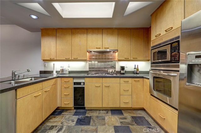 12841 Bloomfield St Unit 103, Studio City, CA 91604 - kitchen with stainless steel appliances, a sink, under cabinet range hood, stone finish flooring, and dark countertops