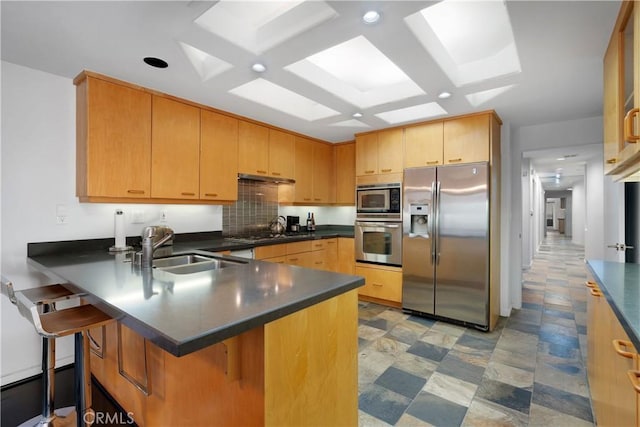 12841 Bloomfield St Unit 103, Studio City, CA 91604 - kitchen with stainless steel appliances, a sink, dark countertops, a peninsula, and recessed lighting