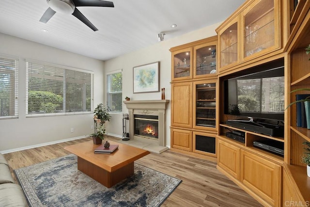 31135 Gleneagles Dr, Temecula, CA 92591 - living room with light wood-style flooring, a glass covered fireplace, a ceiling fan, and recessed lighting
