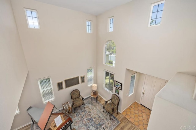 31135 Gleneagles Dr, Temecula, CA 92591 - living area featuring a towering ceiling and light wood-style floors