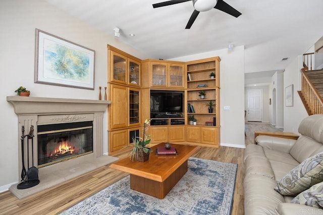 31135 Gleneagles Dr, Temecula, CA 92591 - living area with light wood-style flooring, a ceiling fan, a fireplace, and stairway
