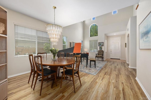 31135 Gleneagles Dr, Temecula, CA 92591 - dining area featuring light wood-type flooring, a chandelier, and healthy amount of natural light
