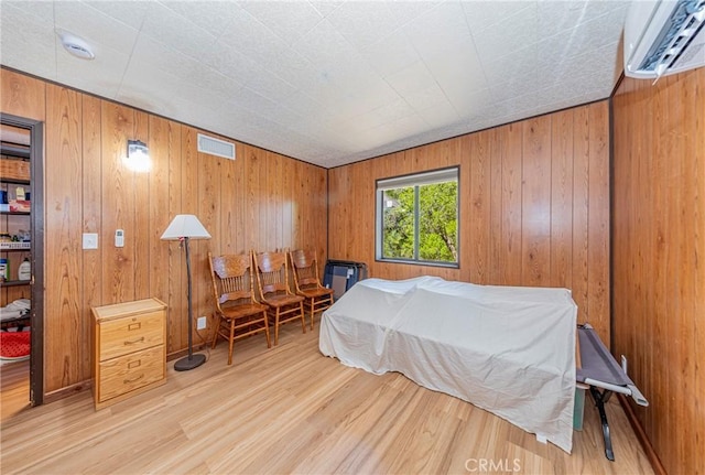 58632 Rainbow Dr, North Fork, CA 93643 - bedroom with a wall mounted AC, wood finished floors, and wood walls