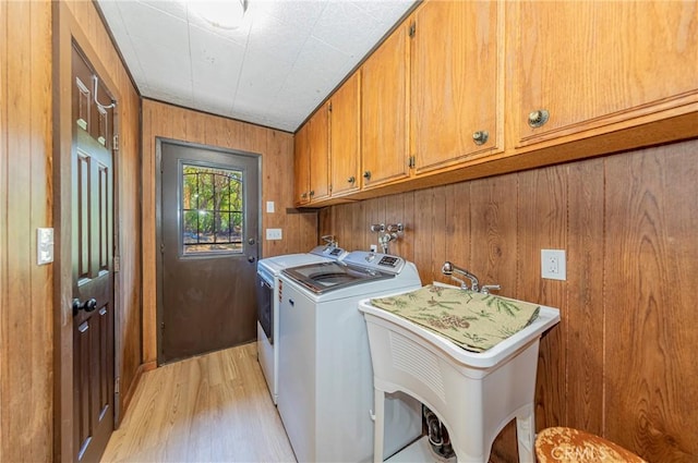 58632 Rainbow Dr, North Fork, CA 93643 - laundry area featuring cabinet space, light wood-style floors, washer and dryer, and wood walls