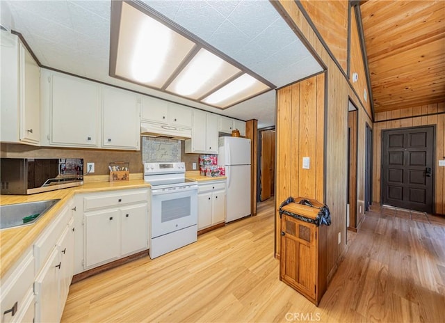 58632 Rainbow Dr, North Fork, CA 93643 - kitchen featuring white appliances, extractor fan, light countertops, wood walls, and light wood-type flooring