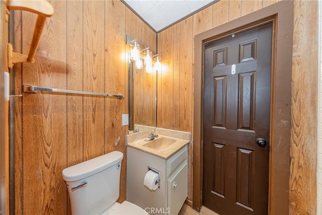 58632 Rainbow Dr, North Fork, CA 93643 - half bath with vanity, toilet, and wood walls