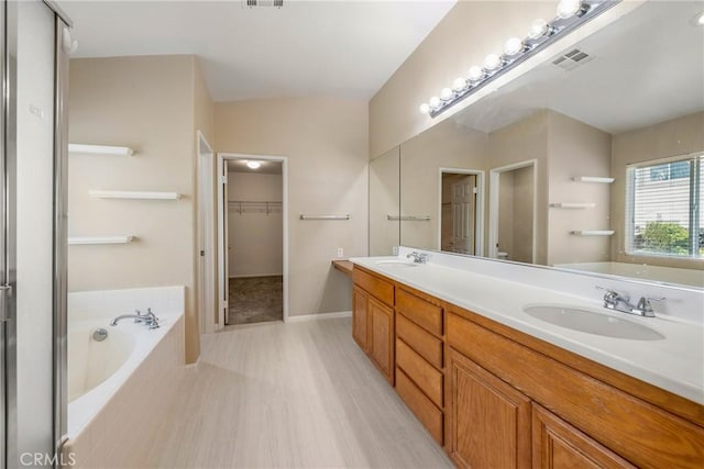 33010 Poppy St, Temecula, CA 92592 - bathroom with double vanity, a garden tub, and a walk in closet
