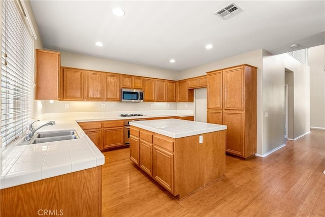 33010 Poppy St, Temecula, CA 92592 - kitchen with appliances with stainless steel finishes, a sink, tile countertops, light wood finished floors, and recessed lighting