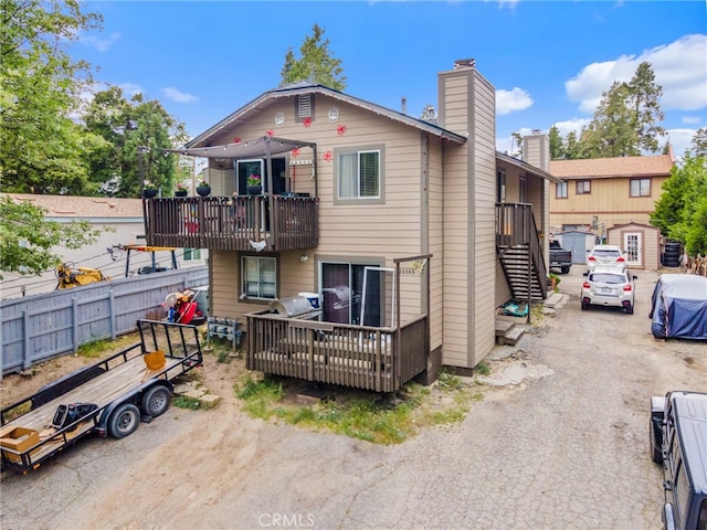 26166 Alpine Ln, Twin Peaks, CA 92391 - view of front of property with a chimney, a balcony, a deck, and stairway