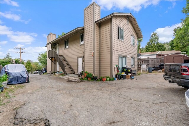 26166 Alpine Ln, Twin Peaks, CA 92391 - view of side of property with a chimney and stairs