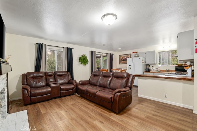 26166 Alpine Ln, Twin Peaks, CA 92391 - living room featuring light wood-style floors, baseboards, and a textured ceiling