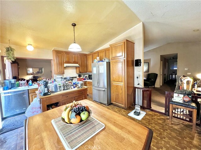 11230 Reliance Dr, Riverside, CA 92505 - kitchen with freestanding refrigerator, lofted ceiling, under cabinet range hood, pendant lighting, and a textured ceiling