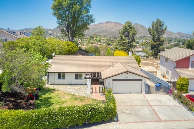 3076 Wauneta St, Newbury Park, CA 91320 - ranch-style home featuring an attached garage, a mountain view, driveway, and stucco siding