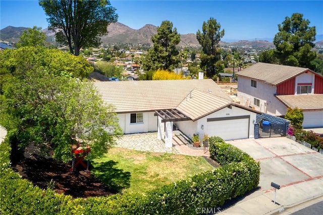 3076 Wauneta St, Newbury Park, CA 91320 - view of front of home featuring a mountain view, a garage, driveway, stucco siding, and a tiled roof