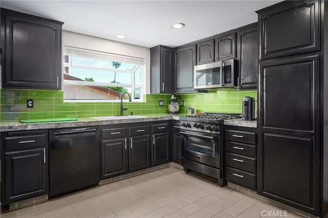 3076 Wauneta St, Newbury Park, CA 91320 - kitchen with appliances with stainless steel finishes, tasteful backsplash, light tile patterned flooring, a sink, and dark cabinetry