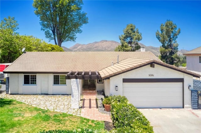 3076 Wauneta St, Newbury Park, CA 91320 - ranch-style home with stucco siding, a mountain view, a garage, and a tile roof