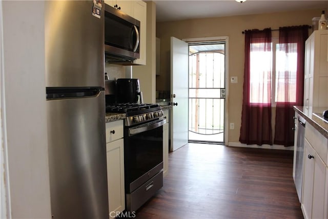 3820 Apache Ave, Bakersfield, CA 93309 - kitchen featuring stainless steel appliances, dark wood-style flooring, and white cabinetry