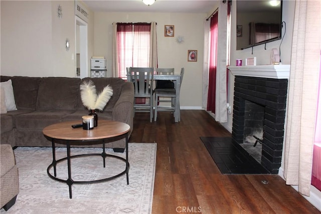 3820 Apache Ave, Bakersfield, CA 93309 - living room featuring wood finished floors, a brick fireplace, and baseboards