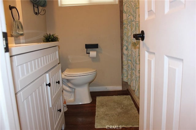 3820 Apache Ave, Bakersfield, CA 93309 - bathroom with toilet, a shower with curtain, baseboards, wood finished floors, and vanity