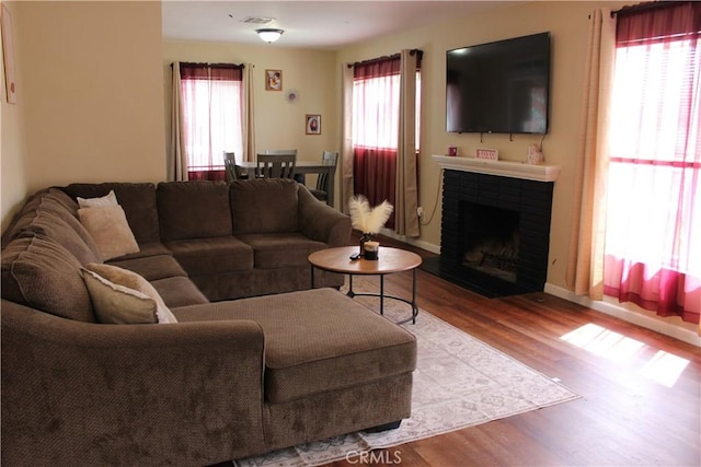 3820 Apache Ave, Bakersfield, CA 93309 - living area featuring wood finished floors, a fireplace, and baseboards