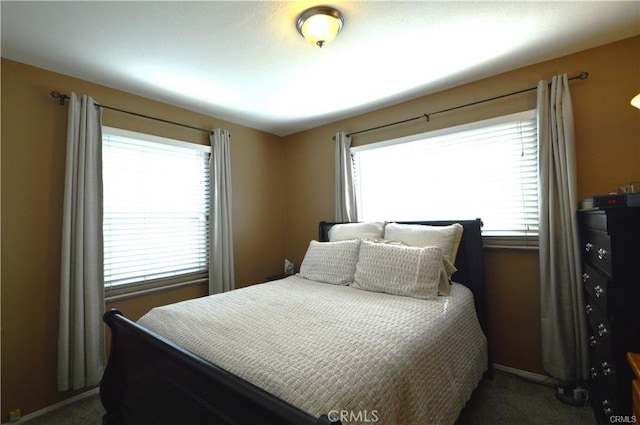 1641 1st St, La Verne, CA 91750 - bedroom with dark colored carpet, multiple windows, and baseboards