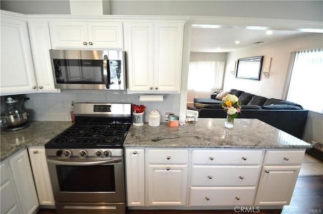 1641 1st St, La Verne, CA 91750 - kitchen featuring stainless steel appliances, plenty of natural light, and white cabinets
