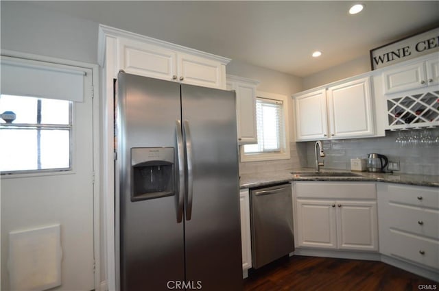 1641 1st St, La Verne, CA 91750 - kitchen with appliances with stainless steel finishes, a sink, white cabinetry, light stone countertops, and backsplash