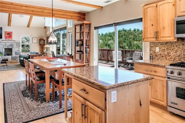 26855 Inyo Ct, Lake Arrowhead, CA 92352 - kitchen with light brown cabinetry, stainless steel appliances, beamed ceiling, a kitchen island, and a fireplace