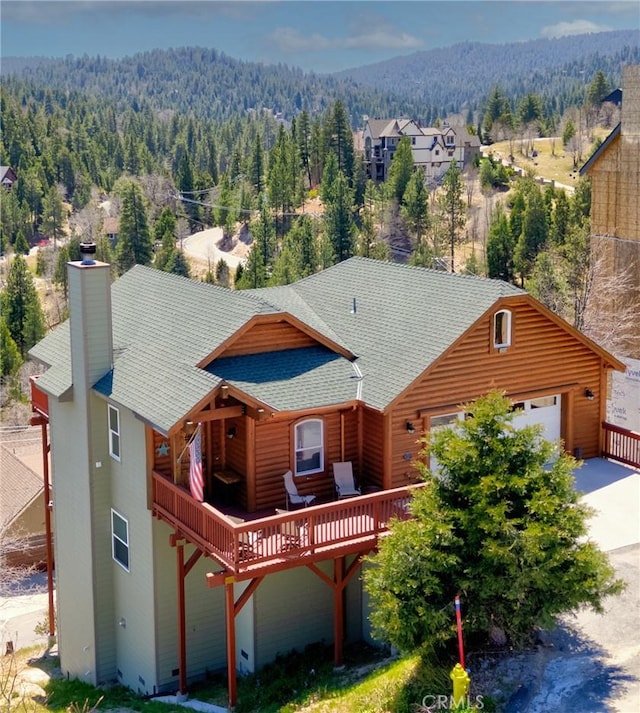 26855 Inyo Ct, Lake Arrowhead, CA 92352 - view of front of property with a view of trees, a shingled roof, and a garage