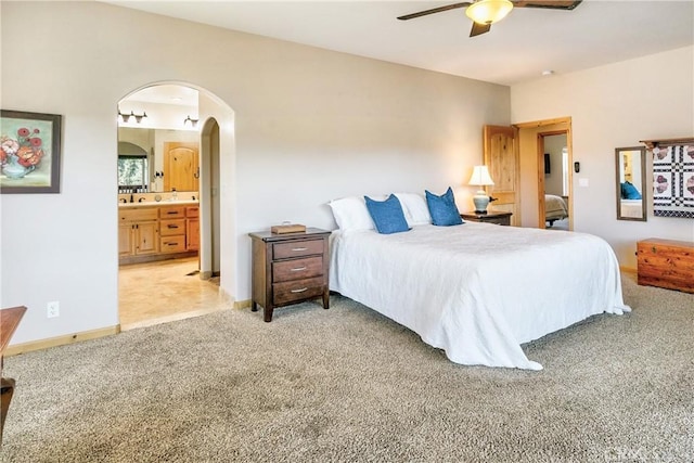 26855 Inyo Ct, Lake Arrowhead, CA 92352 - bedroom with arched walkways, light carpet, connected bathroom, ceiling fan, and a sink