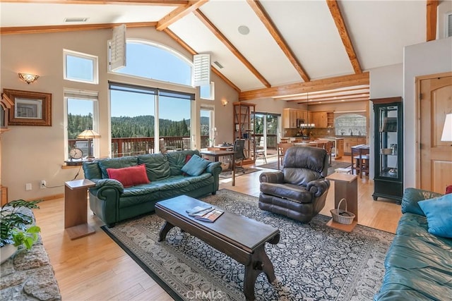 26855 Inyo Ct, Lake Arrowhead, CA 92352 - living area with high vaulted ceiling, light wood finished floors, and beam ceiling