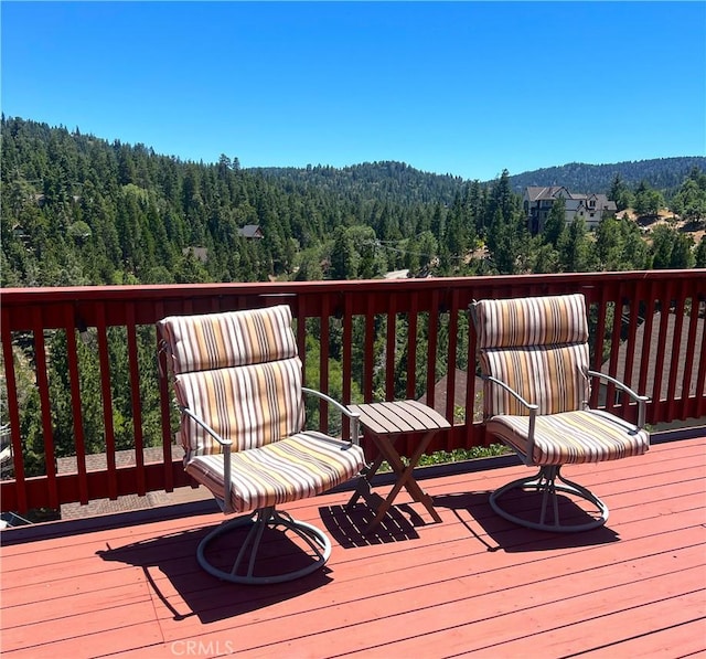 26855 Inyo Ct, Lake Arrowhead, CA 92352 - wooden deck featuring a wooded view