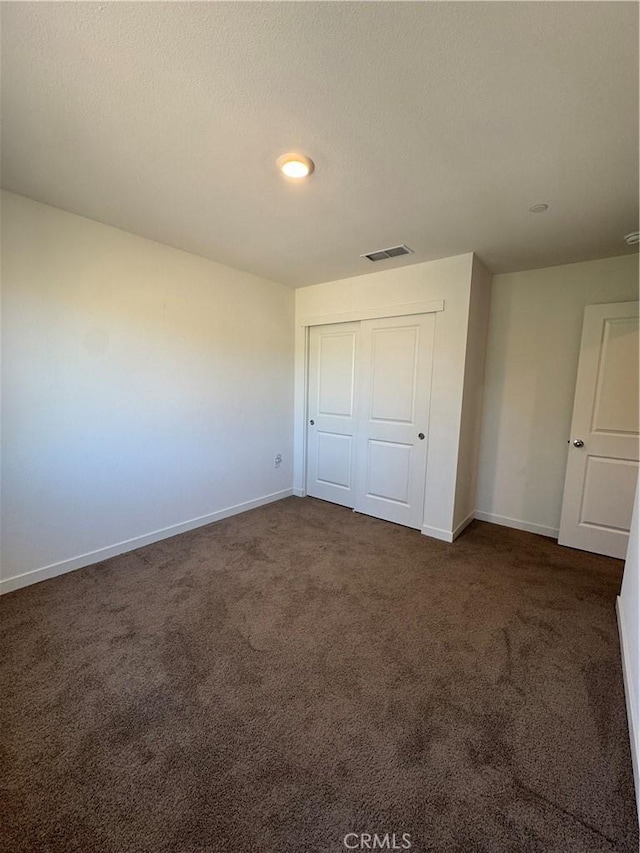 1147 Lentil Way, Chico, CA 95928 - unfurnished bedroom with baseboards, dark carpet, and a closet