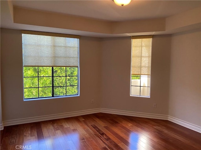 107 N Swall Dr Unit 304, Los Angeles, CA 90048 - spare room featuring plenty of natural light, dark wood-style flooring, and baseboards