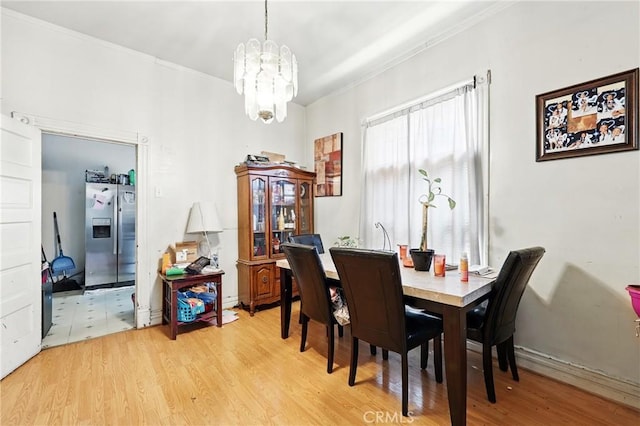 1600 E 33rd St, Los Angeles, CA 90011 - dining area with a chandelier, ornamental molding, and light wood-style flooring