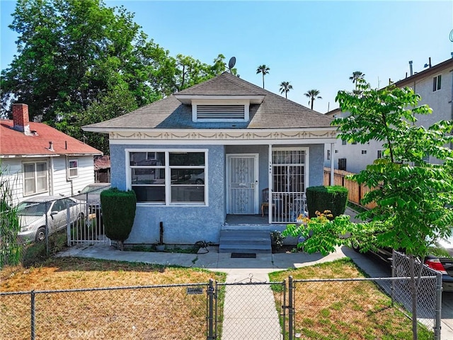 1600 E 33rd St, Los Angeles, CA 90011 - view of front facade featuring a gate, a shingled roof, and stucco siding