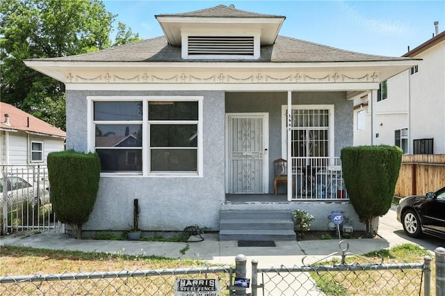 1600 E 33rd St, Los Angeles, CA 90011 - shotgun-style home featuring a porch, stucco siding, and a shingled roof