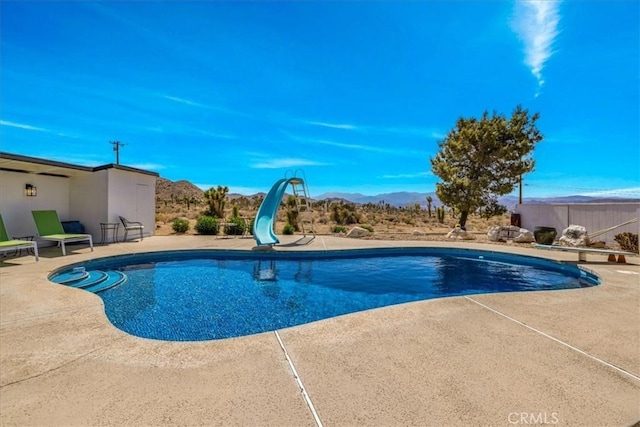 9124 Joshua Ln, Yucca Valley, CA 92284 - view of pool with a water slide, a patio area, and a mountain view
