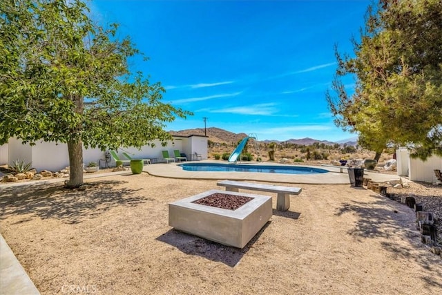 9124 Joshua Ln, Yucca Valley, CA 92284 - outdoor pool with a water slide, a mountain view, and a patio area