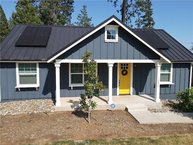 13654 Andover Dr, Magalia, CA 95954 - view of front of home featuring board and batten siding, a porch, and metal roof