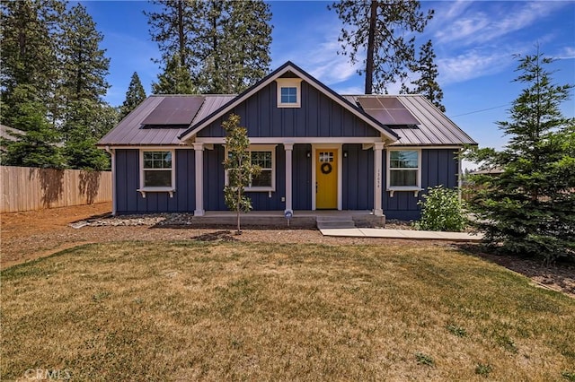 13654 Andover Dr, Magalia, CA 95954 - view of front facade featuring solar panels, a porch, and board and batten siding
