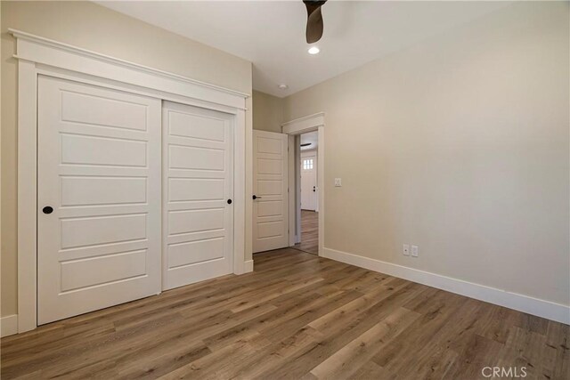 13654 Andover Dr, Magalia, CA 95954 - unfurnished bedroom with baseboards, wood finished floors, a closet, recessed lighting, and a ceiling fan