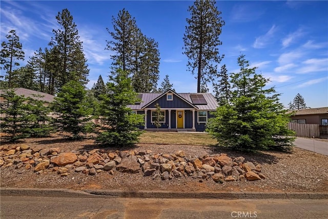 13654 Andover Dr, Magalia, CA 95954 - view of front facade featuring solar panels and metal roof